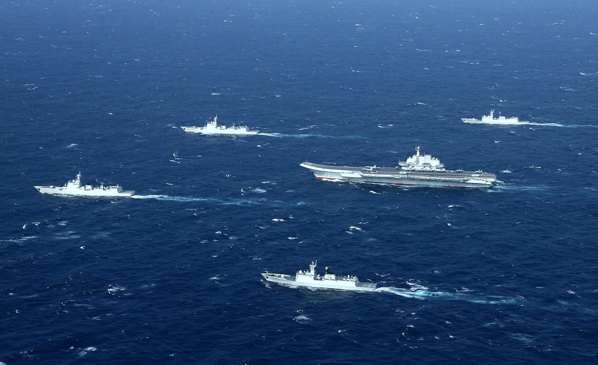 This aerial file photo taken on January 2, 2017 shows a Chinese Navy formation, including the aircraft carrier Liaoning (C), during military drills in the South China Sea (AFP)