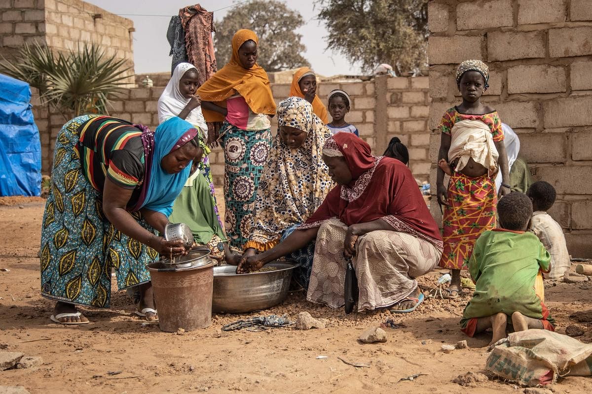 Women and children stand outside an accommodation made available by the community for Internally Displaced People (IDP) from northern Burkina Faso in Kaya. File Photo. Credit: AFP Photo