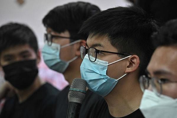 Pro-democracy activist Joshua Wong (centre R) speaks during a press conference in Hong Kong. Credit: AFP