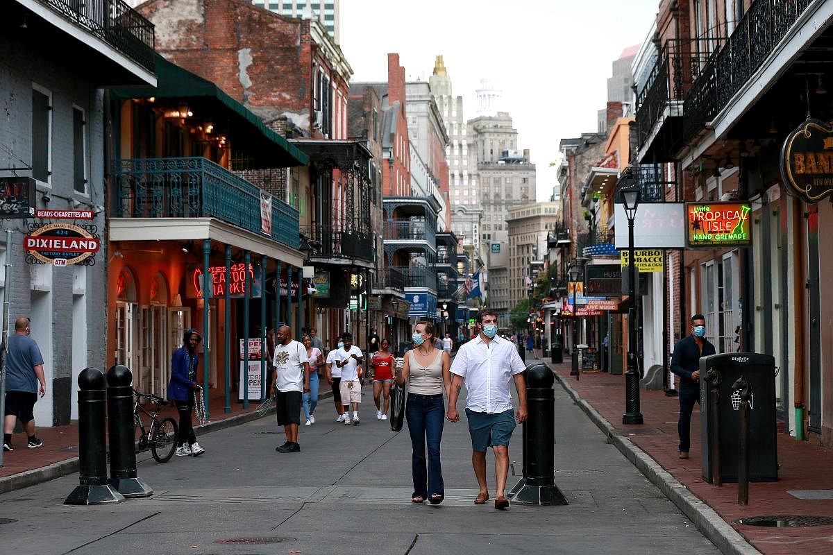 Pedestrians are seen walking along Bourbon Street in the French Quarter in New Orleans, Louisiana. Credit: AFP Photo