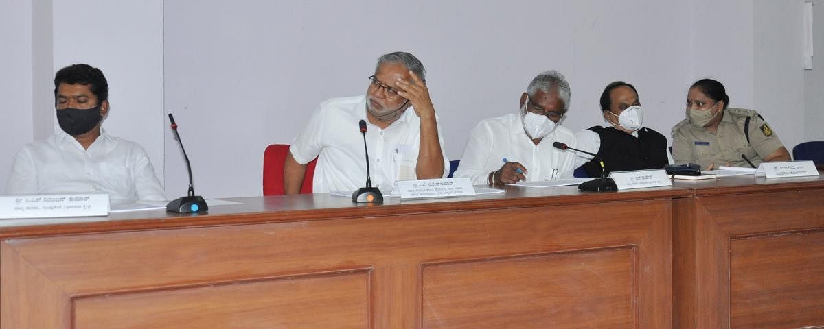 Education Minister S Suresh Kumar chairs a meeting in Chamarajanagar on Wednesday. MLAs C S Niranjan Kumar and N Mahesh, Deputy Commissioner M R Ravi and Superintendent of Police Divya Sara Thomas are seen. DH PHOTO