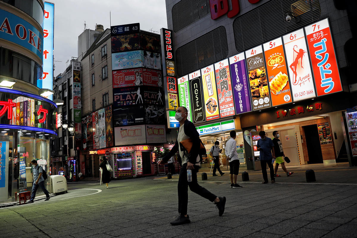 A man wearing a face mask makes his way at the Kabukicho district, amid the coronavirus disease (COVID-19) outbreak in Tokyo. Credit: Reuters 