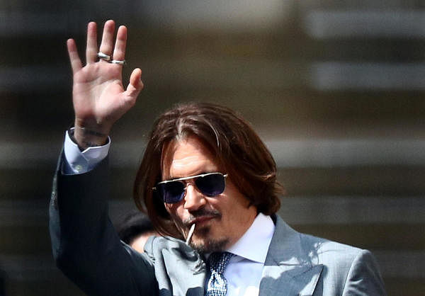 Actor Johnny Depp waves as he leaves the High Court in London, Britain July 16, 2020. Credit: AFP Photo