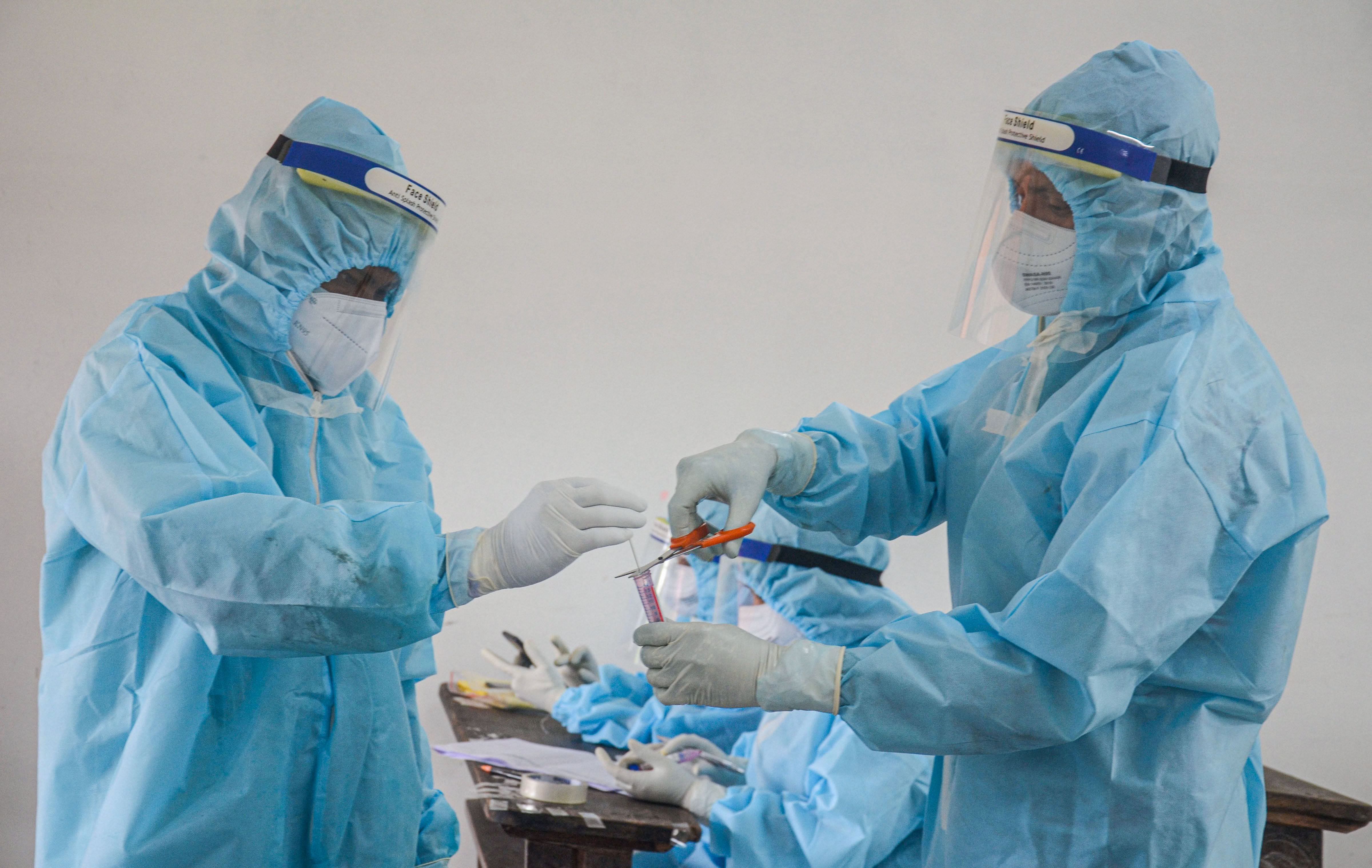 Medics prepare to collect swab samples for COVID-19 testing, in Dibrugarh district. Credit: PTI