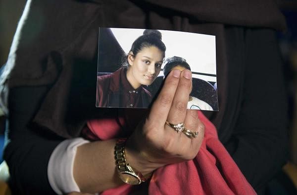 Renu Begum, eldest sister of missing British girl Shamima Begum, holds a picture of her sister while being interviewed by the media in central London. Credit: AFP Photo