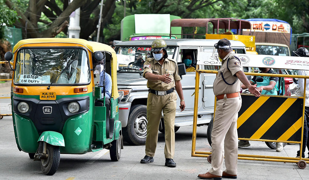 Police check vehicles on Kasturba Road on the first day of the lockdown on Wednesday. DH PHOTO/RANJU P