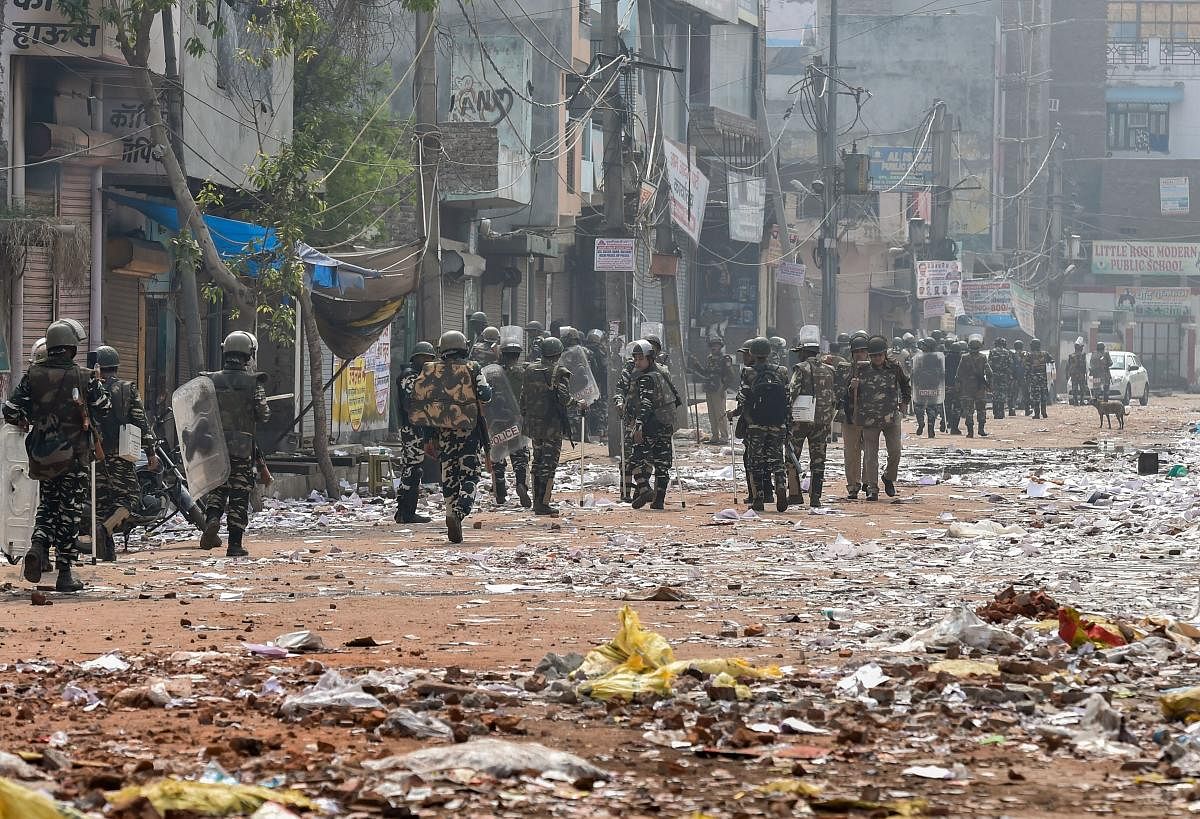 Security personnel conduct patrolling as they walk past Bhagirathi Vihar area of the riot-affected north east Delhi, Feb. 26, 2020. (PTI)