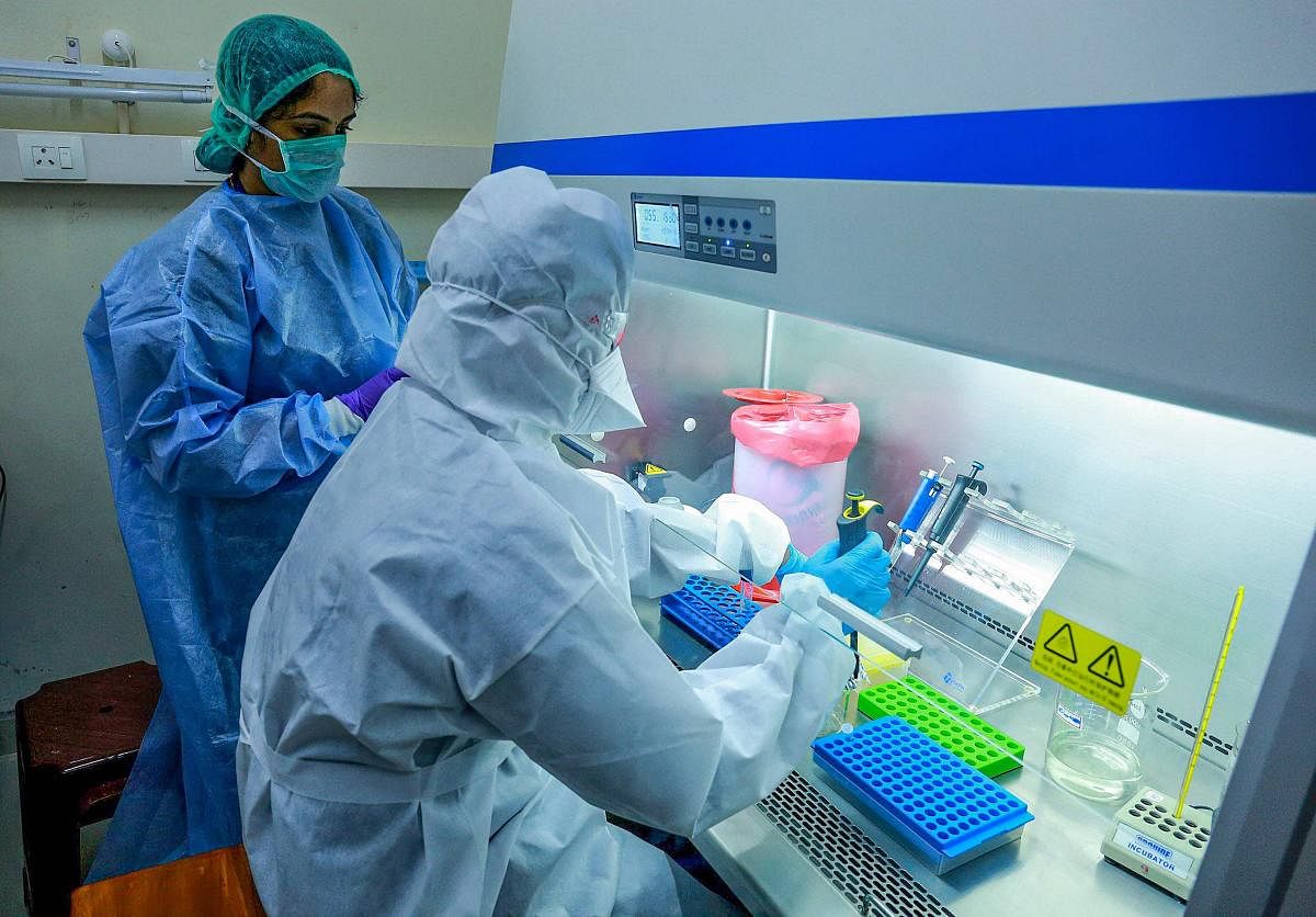 Medics at the real-time Polymerase Chain Reaction laboratory (PCR lab) at the Kalamassery Medical College Hospital, during the nationwide lockdown in wake of the coronavirus pandemic, in Kochi, Thursday, April 16, 2020.  Credit: PTI Photo