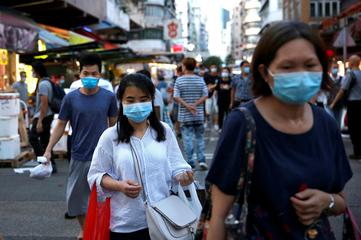 People wear surgical masks at a wet market following the coronavirus disease outbreak at Sham Shui Po, one of the oldest districts in Hong Kong. Credit: Reuters