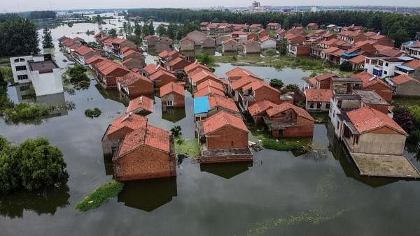 An aerial view shows flooded residential buildings due to rising water levels of the Yangtze river in Jiujiang, China's central Jiangxi province. Credit: AFP