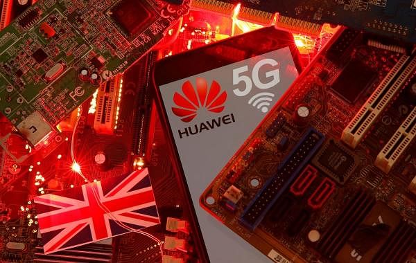 The British flag and a smartphone with a Huawei and 5G network logo are seen on a PC motherboard in this illustration. Credit: Reuters