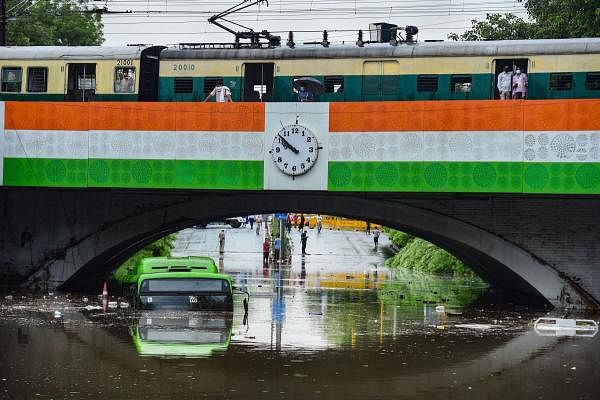 A DTC bus almost submerged at waterlogged Minto Bridge underpass after rains in New Delhi. Credit: PTI Photo