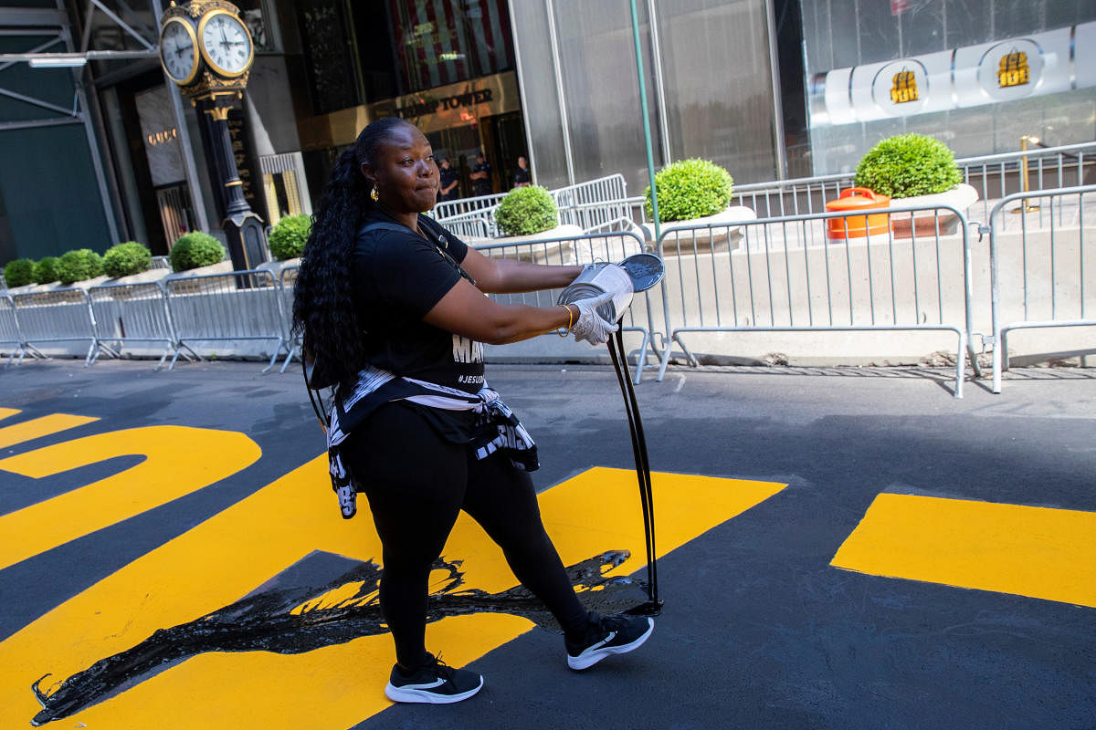 A protester pours paint on the Black Lives Matter mural outside of Trump Tower on Fifth Avenue in Manhattan. Credit: Reuters