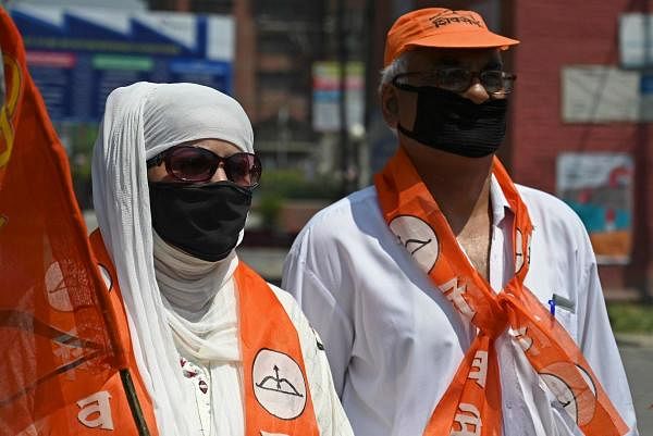 Shiv Sena activists hold party flags. Credit: AFP