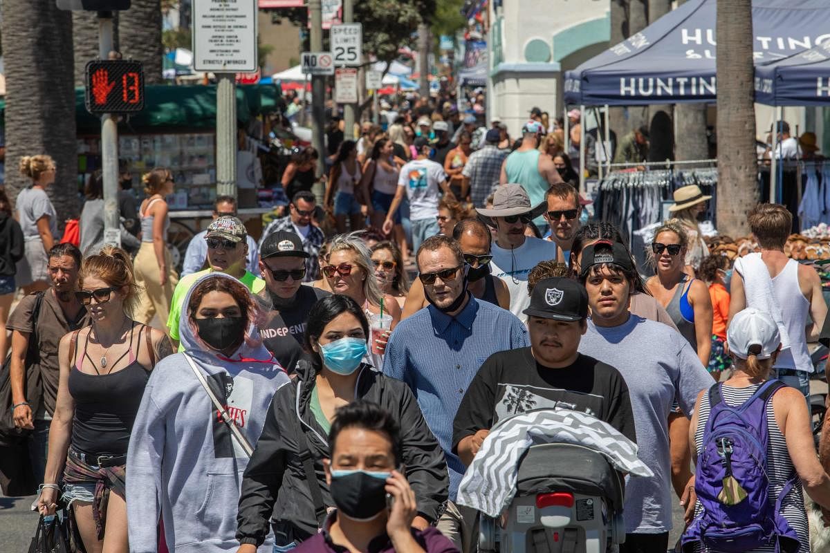 People cross the street in Huntington Beach, California, on July 19, 2020 amid the coronavirus pandemic. Credit: AFP Photo