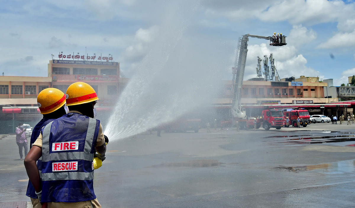 Firemen sanitise Majestic bus stand in Bengaluru.DH photo