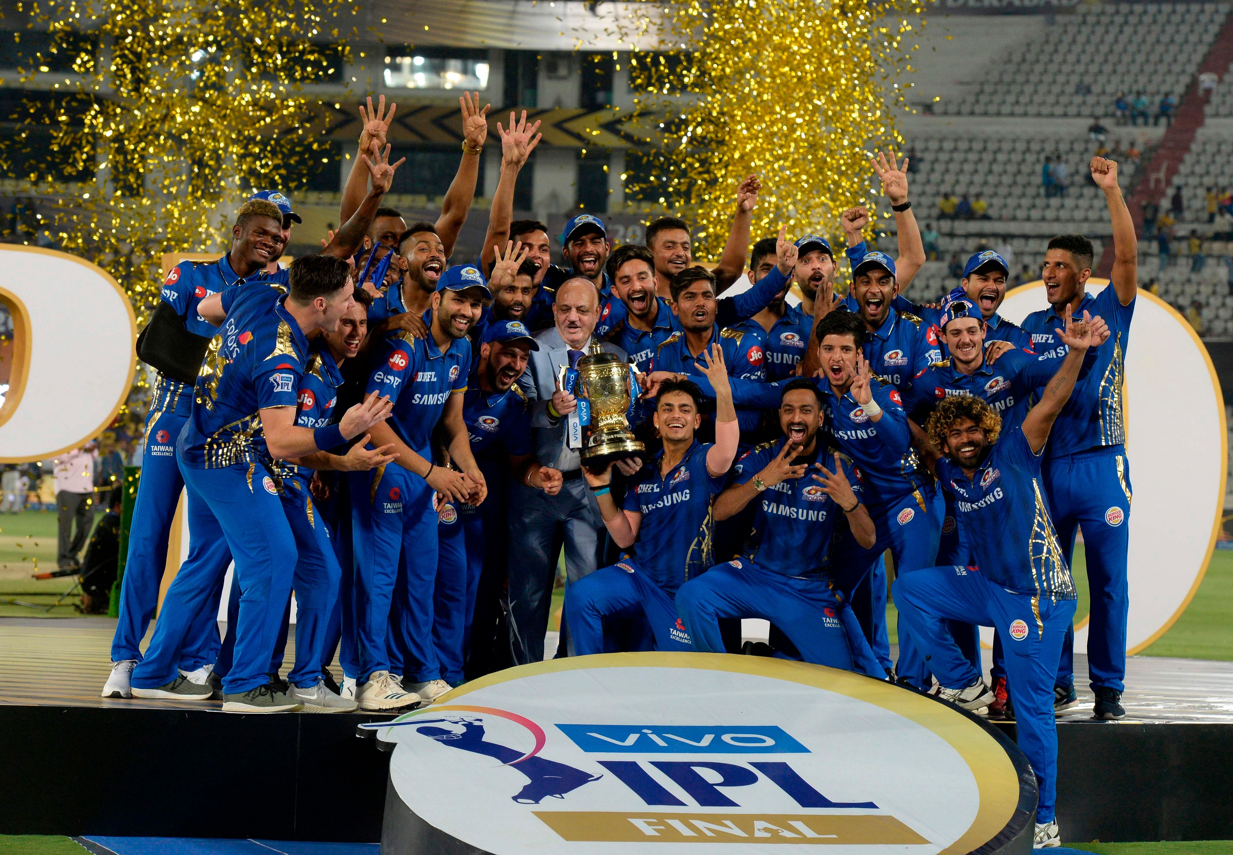 In this file photo taken on May 13, 2019 Mumbai Indians team players hold the trophy as they celebrate their victory against Chennai Super Kings after the 2019 Indian Premier League. Credit: AFP Photo