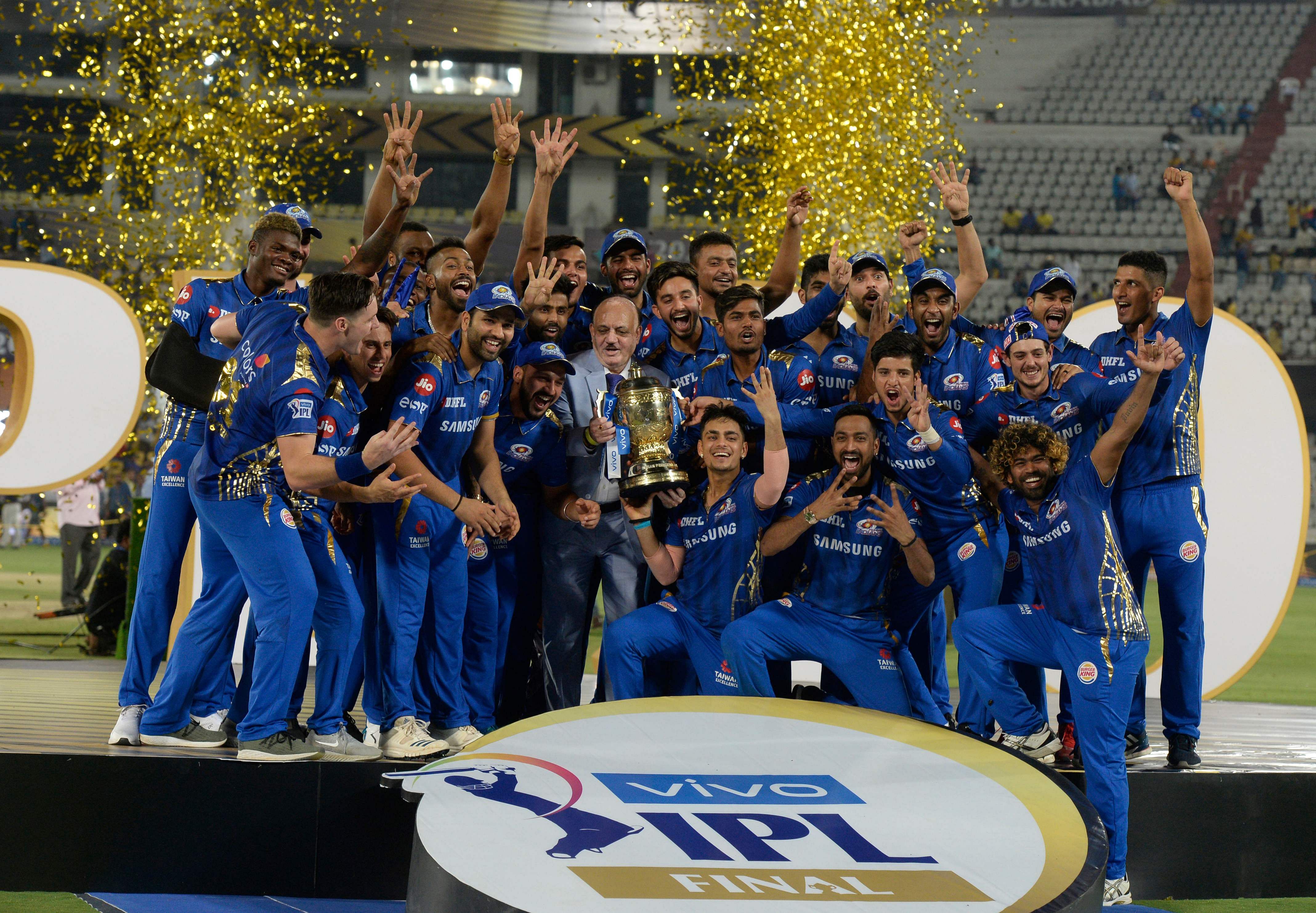 In this file photo taken on May 13, 2019 Mumbai Indians team players hold the trophy as they celebrate their victory against Chennai Super Kings after the 2019 Indian Premier League. Credit: AFP Photo