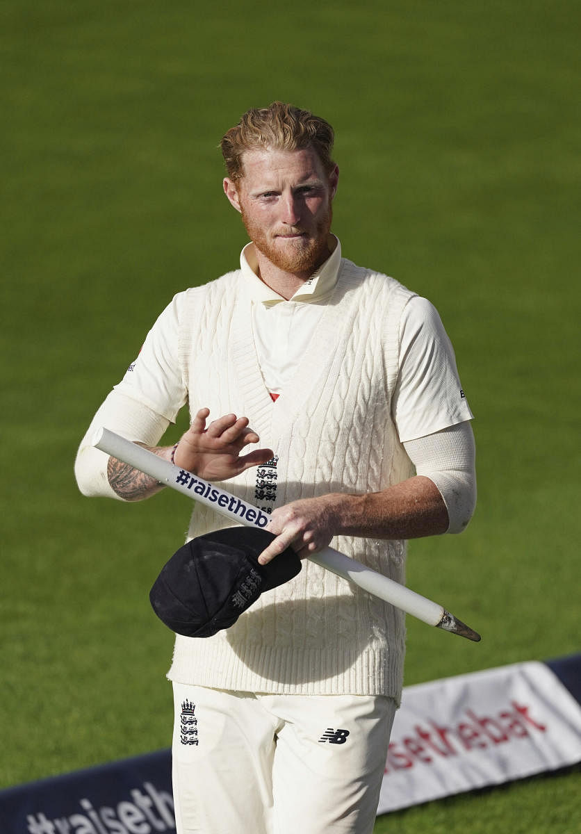 England's Ben Stokes walks off the field carrying a stump after their win on the last day of the second cricket Test match between England and West Indies at Old Trafford in Manchester. Credit: AP Photo