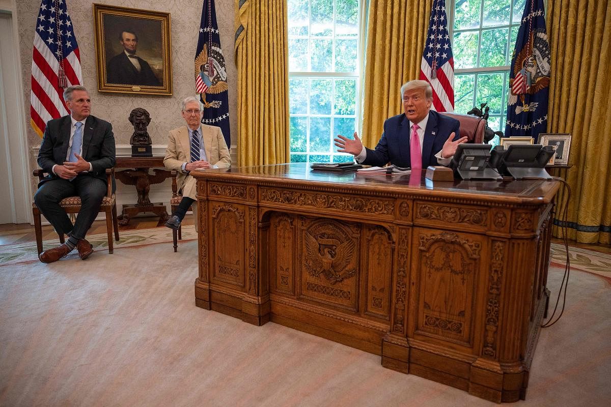 US President Donald Trump speaks with Senate Majority Leader Mitch McConnell (C), R-KY, and House Minority Leader Kevin McCarthy (L) Credit: AFP File Photo  