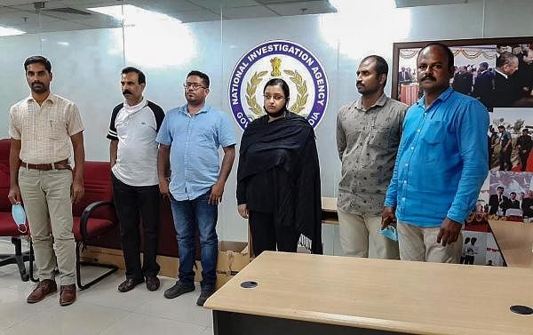 Kerala gold smuggling case accused Swapna Suresh and Sandeep Nair (both in middle) after they were arrested by the National Investigation Agency in Bengaluru, Karnataka. Credit: PTI Photo