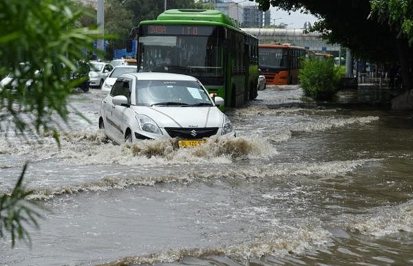 Vehicles ply on a waterlogged street at ITO following heavy rainfall, in New Delhi. Credit: PTI Photo