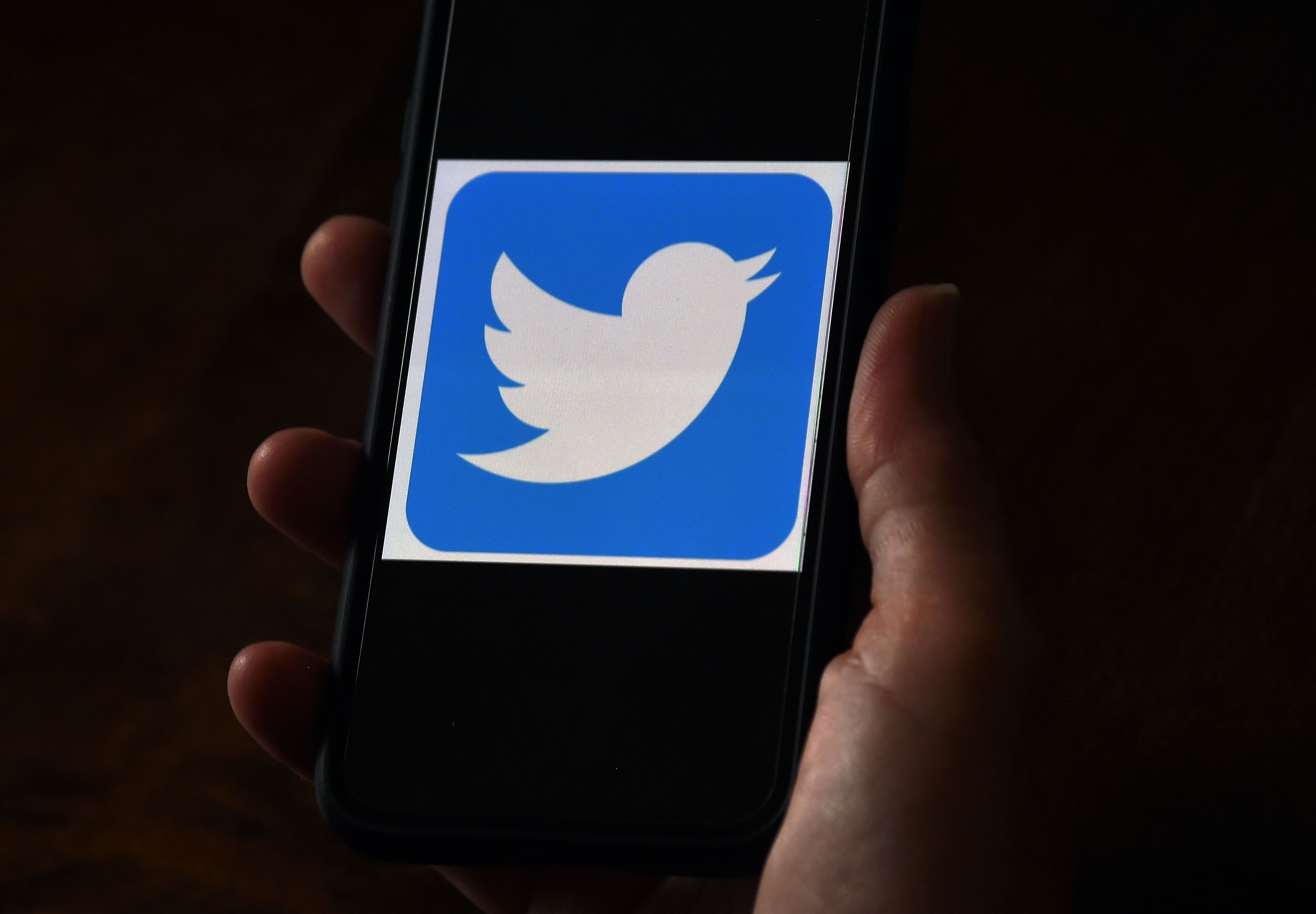 Twitter, which announced the change on its Twitter Safety page, said it would not serve content and accounts associated with QAnon in trends and recommendations, and would block URLs associated with the group from being shared on the platform. Credit: AFP