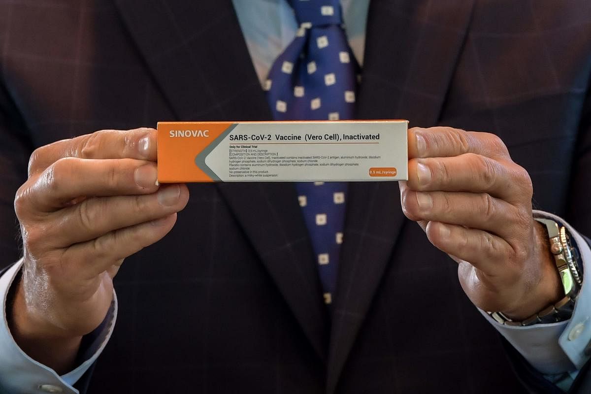 Sao Paulo State Governor Joao Doria displays a box of the Covid-19 vaccine produced by the Chinese company Sinovac Biotech at the Hospital das Clinicas (HC) in Sao Paulo State, during its trial stage. Credit: AFP Photo