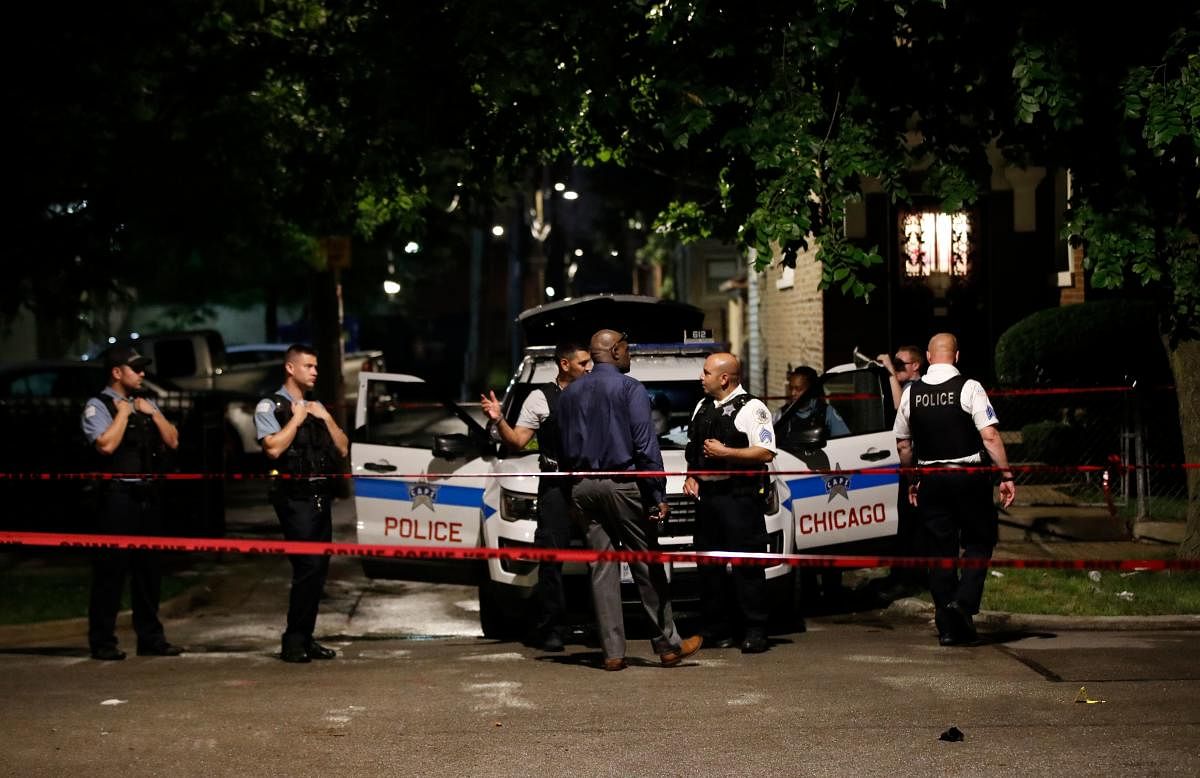 Chicago Police officers investigate the scene of a shooting in Chicago, Illinois. Credit: AP Photo