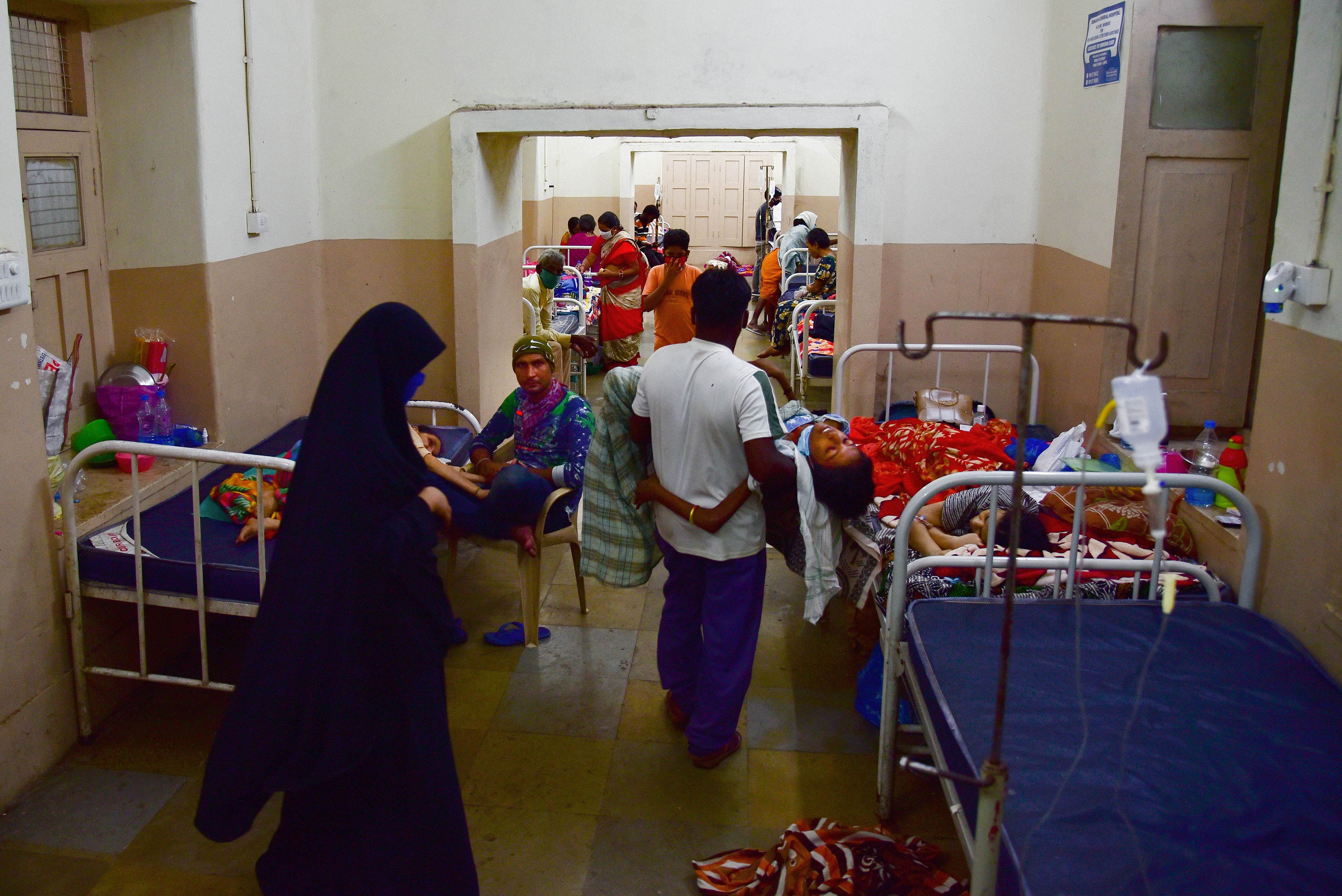 Patients being shifted to the new building after the authorities announced to vacate the old building of Osmania General Hospital which was submerged following heavy rainfall. Credit: PTI Photo