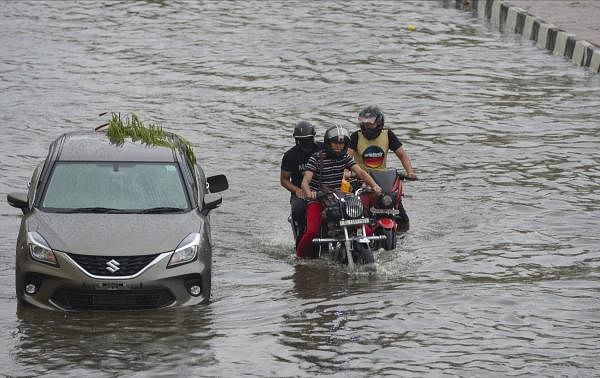 Vehicles ply on a waterlogged street during heavy rain, in New Delhi. Credit: PTI Photo