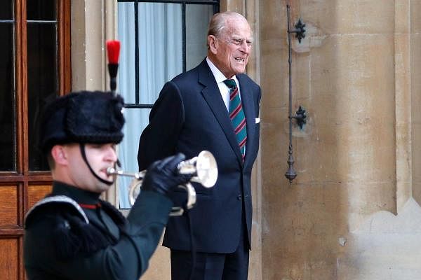 Britain's Prince Philip (R), Duke of Edinburgh listens to buglers during the transfer of the Colonel-in-Chief of The Rifles at Windsor castle in Windsor. Credit: AFP Photo