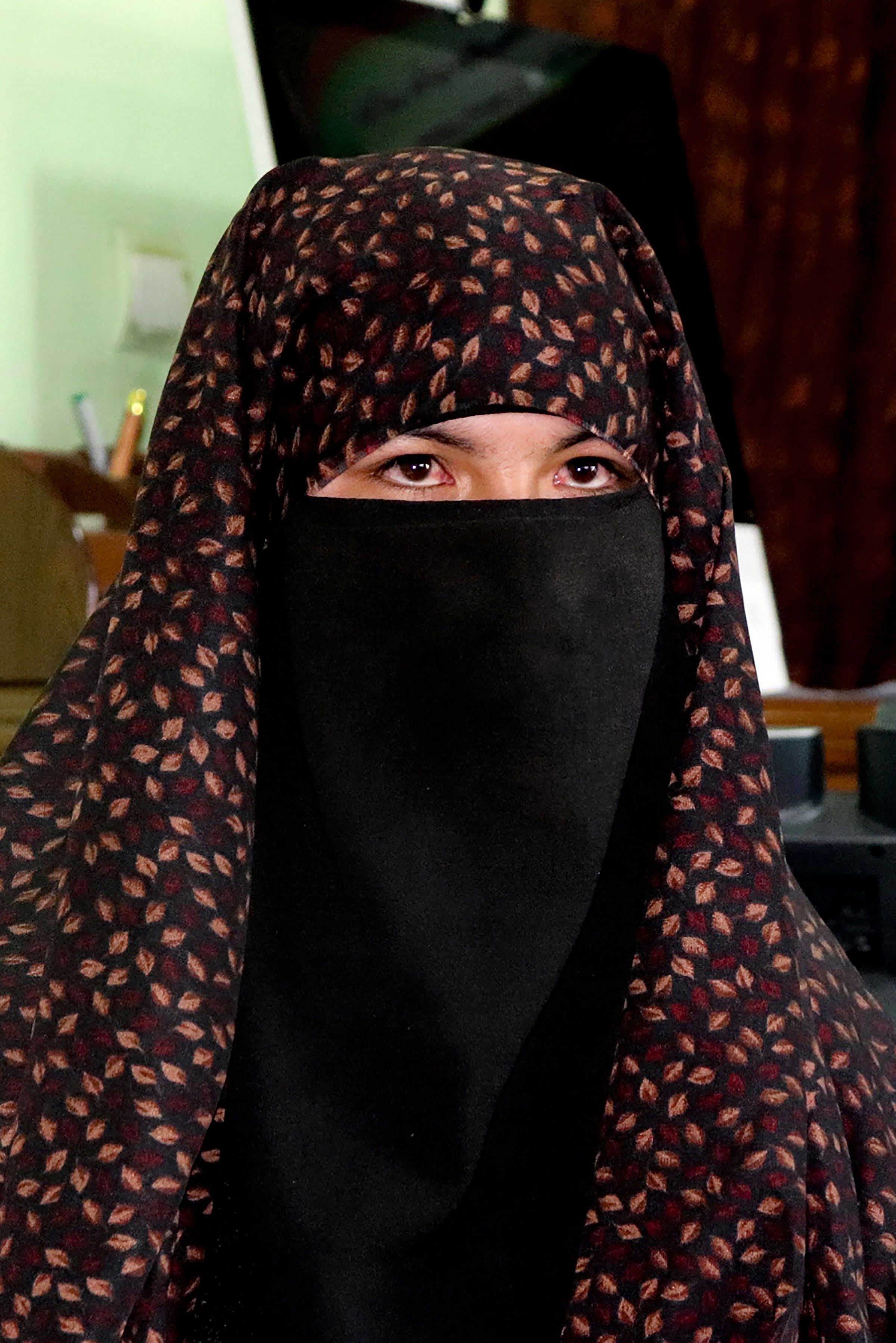 Qamar Gul, 15, who shot with an AK-47 gun two Taliban fighters after they attacked her home, sits at the Governor's office in Feroz Koh. Credits: AFP Photo