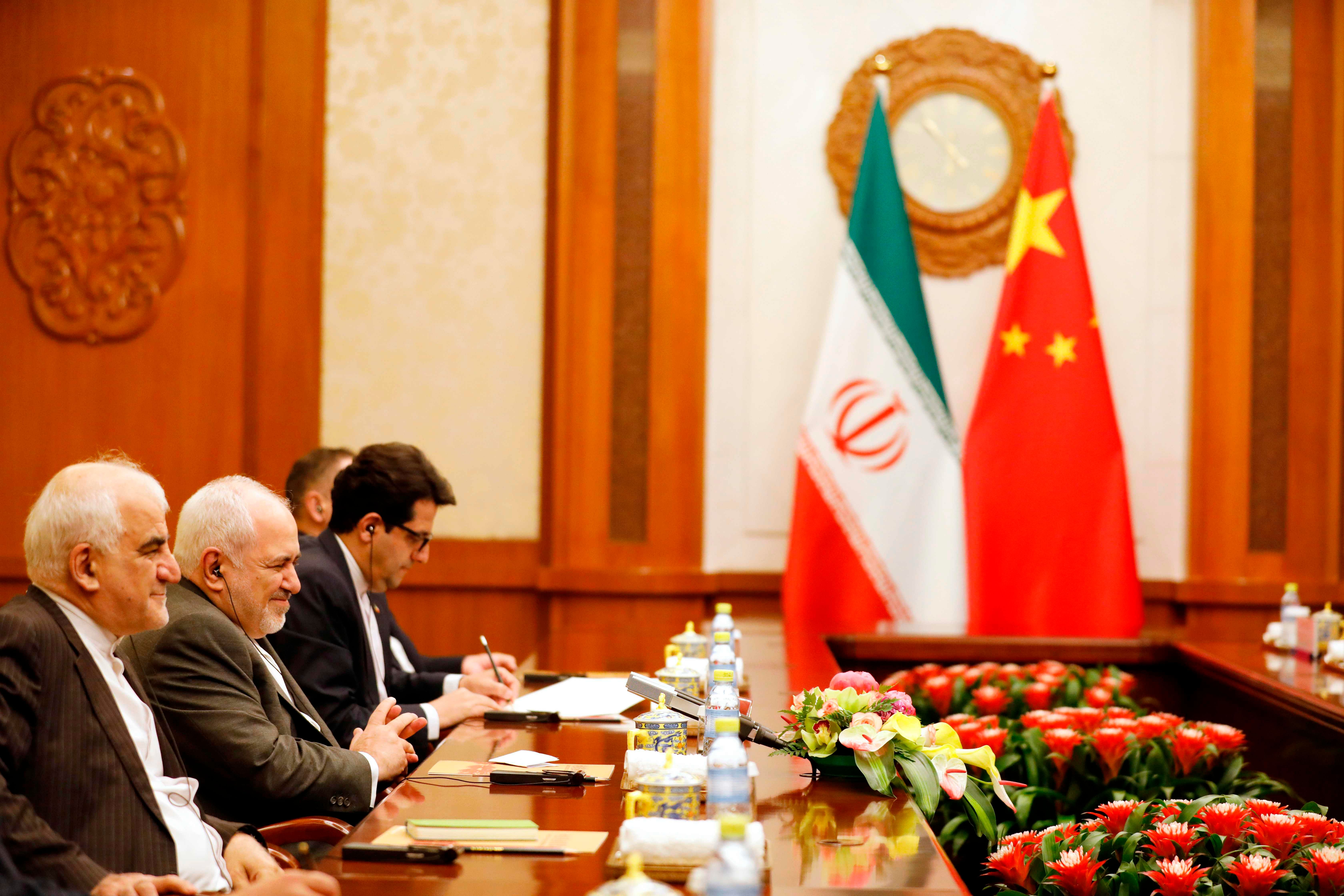 Iranian Foreign Minister Mohammad Javad Zarif (2-L) speaks with Chinese Foreign Minister Wang Yi. Credit: AFP