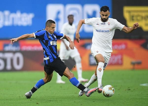 Inter Milan's Alexis Sanchez in action with Fiorentina's Rachid Ghezzal, as play resumes behind closed doors following the outbreak of the coronavirus disease. Credit: Reuters