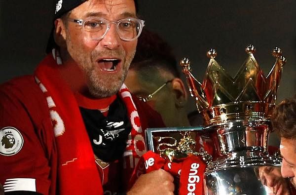 Liverpool's German manager Jurgen Klopp poses with the Premier League trophy. Credit: AFP Photo