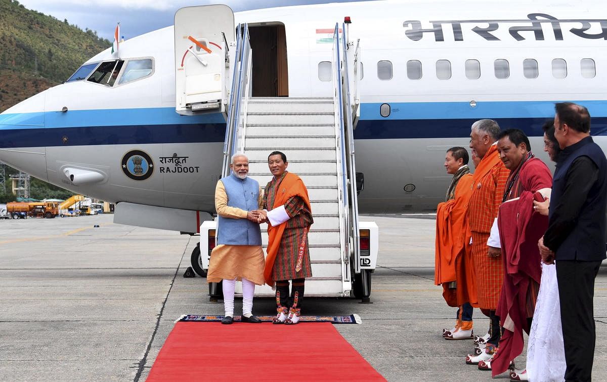 Paro: Prime Minister Narendra Modi being welcomed by his Bhutanese counterpart Lotay Tshering on his arrival at Paro International Airport, Saturday, Aug 17, 2018. (Twitter/PTI Photo) (PTI8_17_2019_000038B)