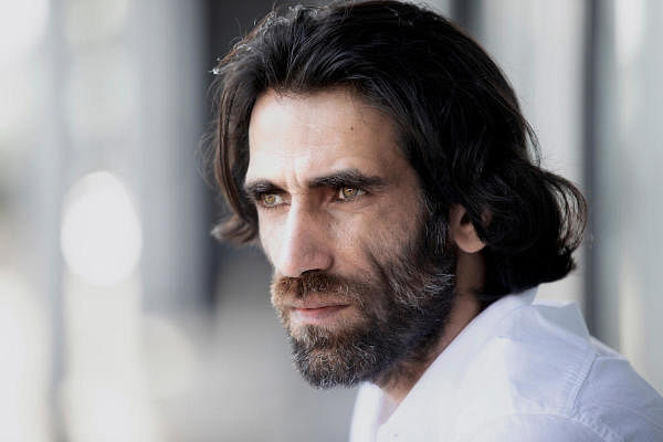 Kurdish-Iranian born journalist Behrouz Boochani, who spent six years in an Australian-run Manus Island detention centre, poses for a photo in Christchurch. Credit: Reuters