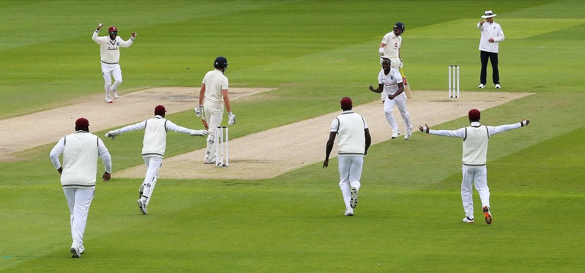 West Indies' Kemar Roach celebrates taking the wicket of England's Dom Sibley lbw with teammates, as play resumes behind closed doors following the outbreak of the coronavirus disease. Credit: Reuters