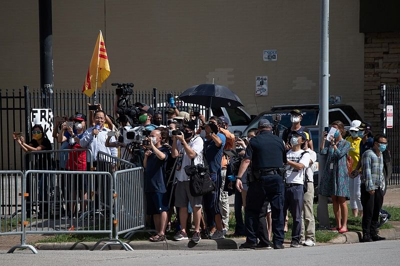 Activists and media stand behind barricades after the closure of China’s Consulate n Houston. Credits: Reuters Photo