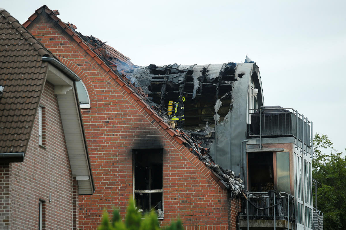 Rescue forces are seen at the scene where an ultra-light aircraft has crashed into a residential building in Wesel, Germany. Credit: Reuters Photo
