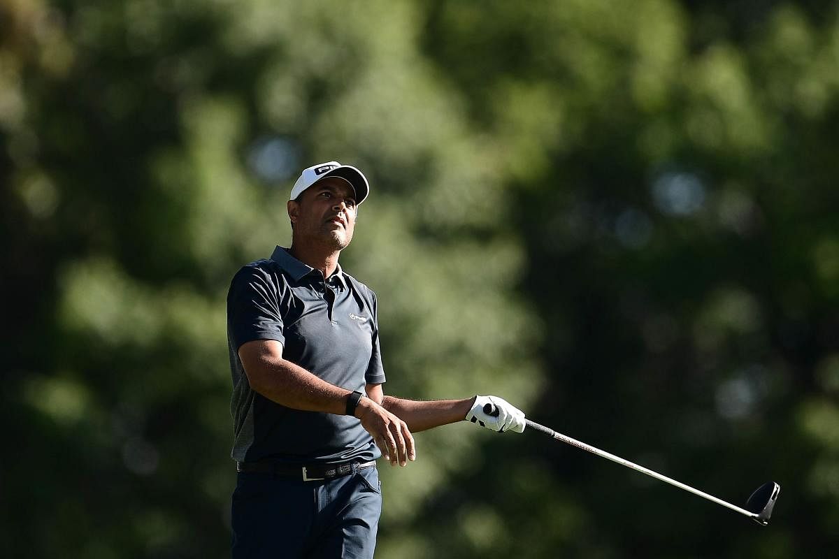 Arjun Atwal of India plays his shot from the 11th tee during the first round of the 3M Open. Credit: AFP Photo