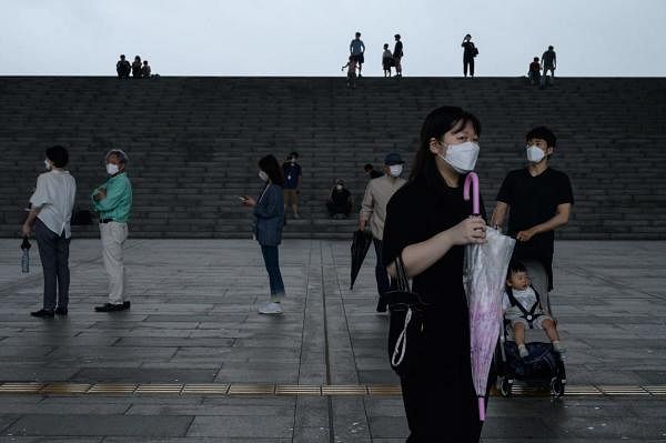 Visitors wearing face masks arrive at the National Museum of Korea in Seoul. Credit: AFP