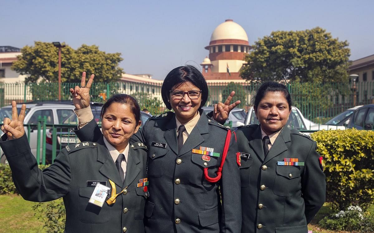 New Delhi: (L-R)- Short Service Commission women officers Anjali Bisht, Seema Singh and Sandhya Yadav flash victory sign outside the Supreme Court in New Delhi, Monday, Feb. 17, 2020. The apex court on Monday ruled that women officers should get Permanent
