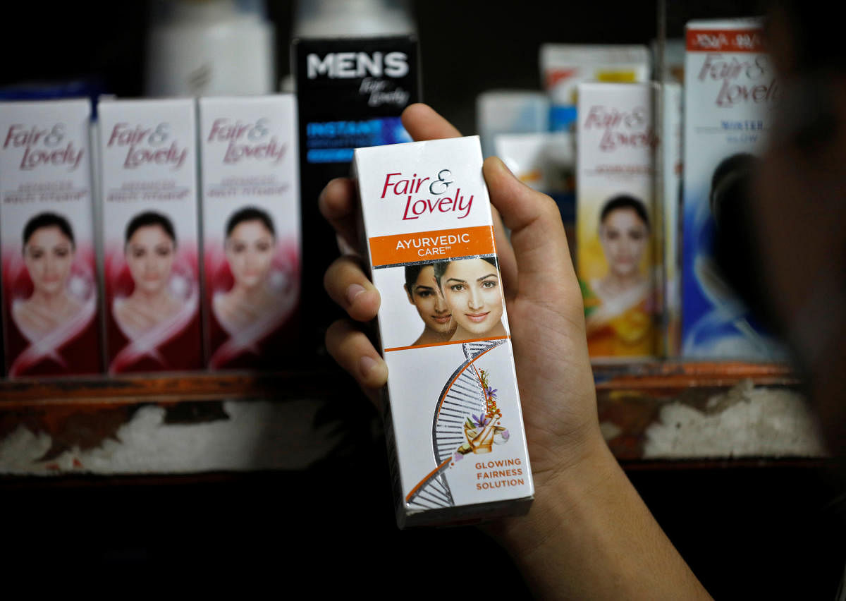 A customer picks up "Fair &amp; Lovely" brand of skin lightening product from a shelf in a shop in Ahmedabad, India, June 25, 2020. REUTERS/Amit Dave