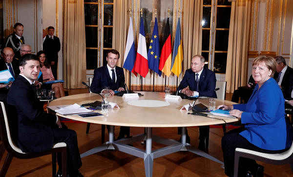 Representative Photo. Ukrainian President Volodymyr Zelenskiy, German Chancellor Angela Merkel, French President Emmanuel Macron and Russian President Vladimir Putin attend a working session during a summit on the conflict in Ukraine at the Elysee Palace in Paris, in 2019. Credit: Reuters