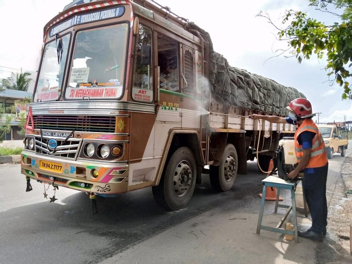 A goods lorry entering Kerala being sanitised at Talapady border.