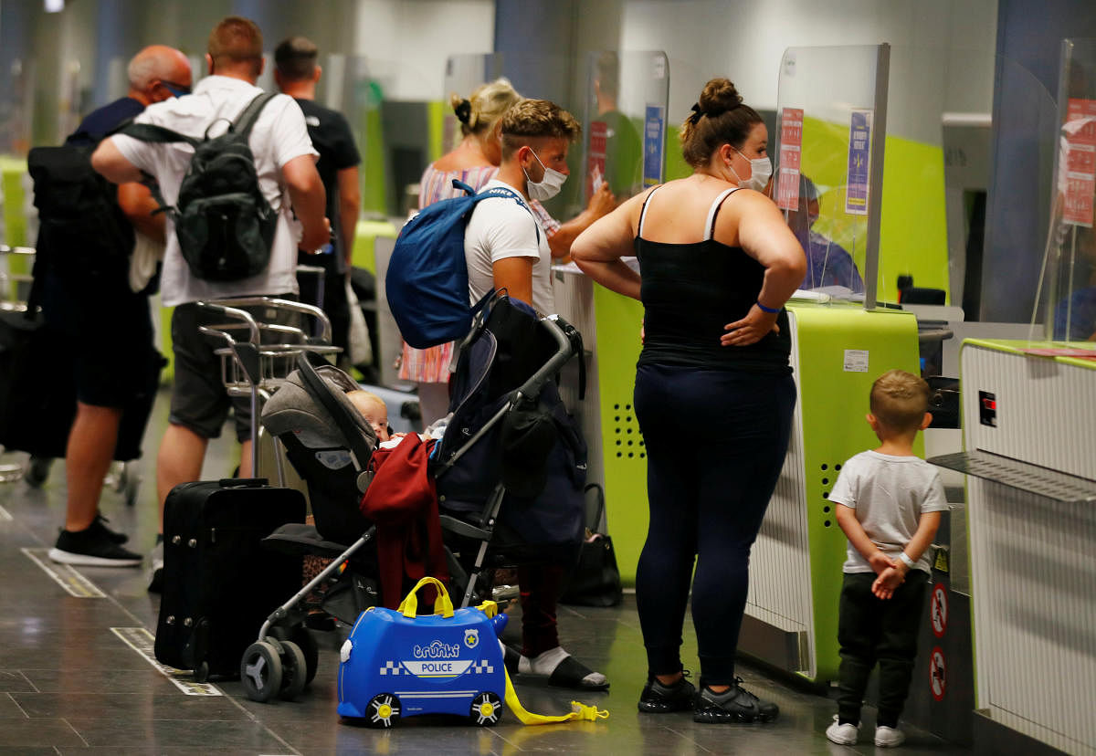 British tourists returning to UK, check in their luggage, as Britain imposed a two-week quarantine on all travellers arriving from Spain. Credit: Reuters