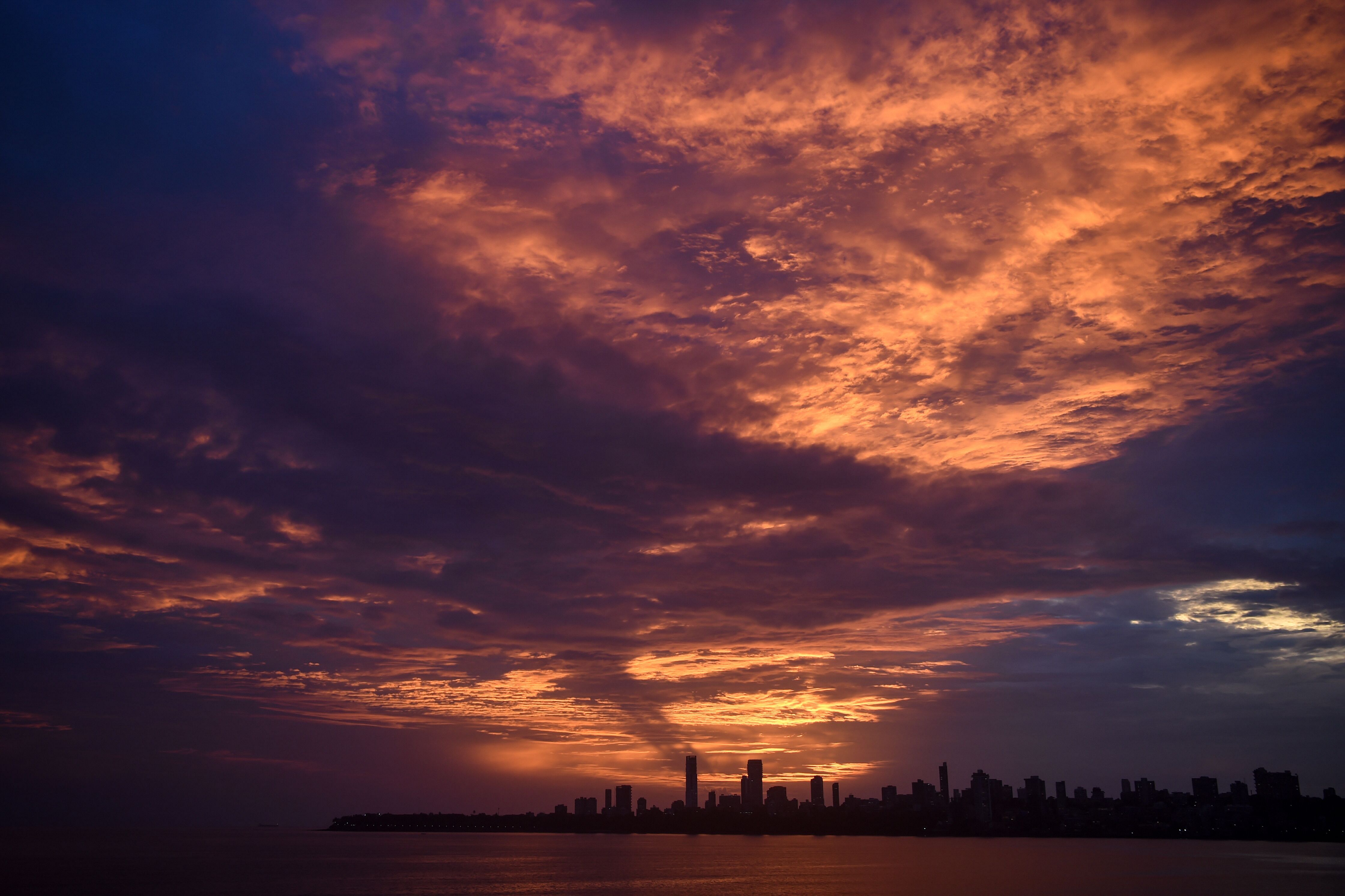 The sun sets over the city skyline in Mumbai. Credit: AFP Photo