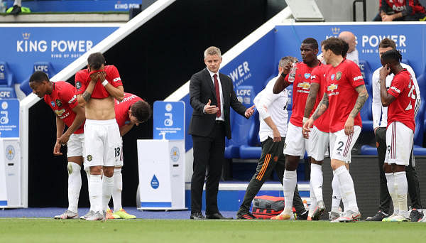 Manchester United manager Ole Gunnar Solskjaer speaks to his players during a drinks break, as play resumes behind closed doors following the outbreak of the coronavirus disease. Credit: Reuters
